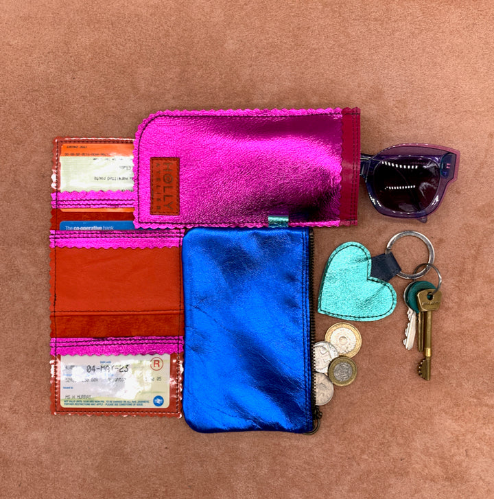 A flat lay of electric coloured leather accessories