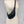 Load image into Gallery viewer, Small crossbody bag in matte black leather worn across a mannequin
