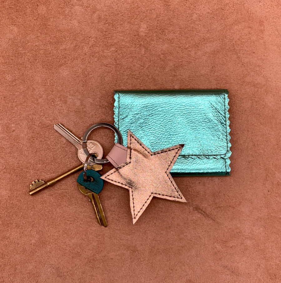 Soft leather card wallet in turquoise with a gold star keyring.