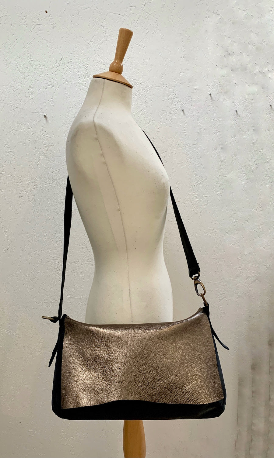 Soft Leather Shoulder Bag in gold and black on a mannequin