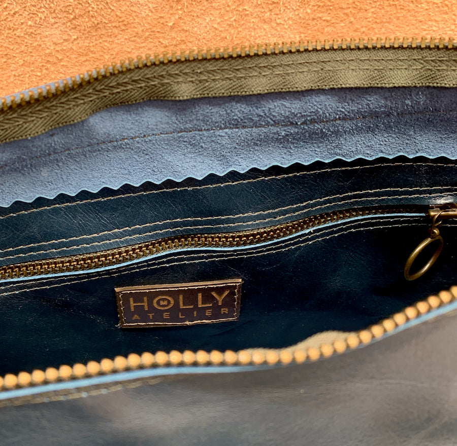 Close up of inside of Soft Leather Shoulder Bag in gold and black