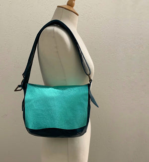 Flat Front Soft Leather Shoulder Bag in electric turquoise on a mennequin