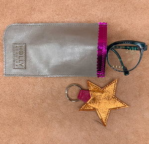 Leather star kering in electric orange with a glasses case.